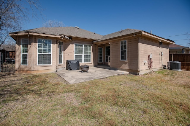 back of house featuring roof with shingles, central air condition unit, a lawn, a patio area, and fence