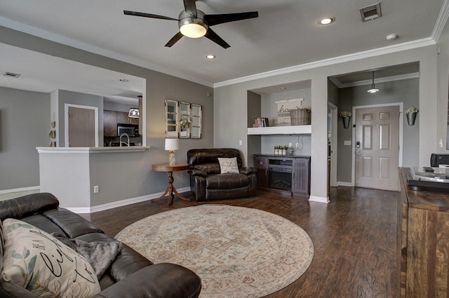 living area featuring a dry bar, dark wood finished floors, visible vents, and baseboards