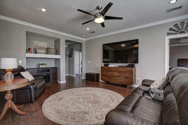 living room with ornamental molding, visible vents, and wood finished floors