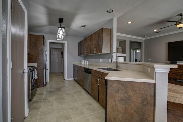 kitchen with visible vents, a peninsula, stainless steel appliances, light countertops, and a sink