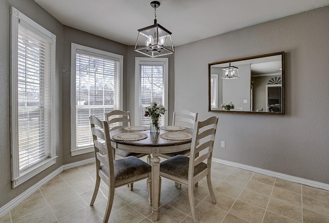 dining area featuring baseboards, a notable chandelier, and light tile patterned flooring