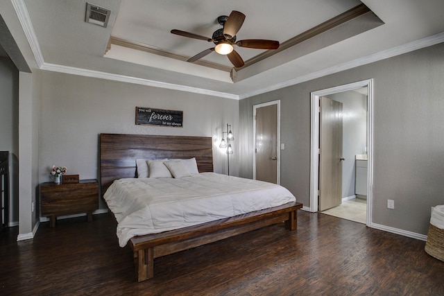 bedroom with ornamental molding, a raised ceiling, visible vents, and wood finished floors