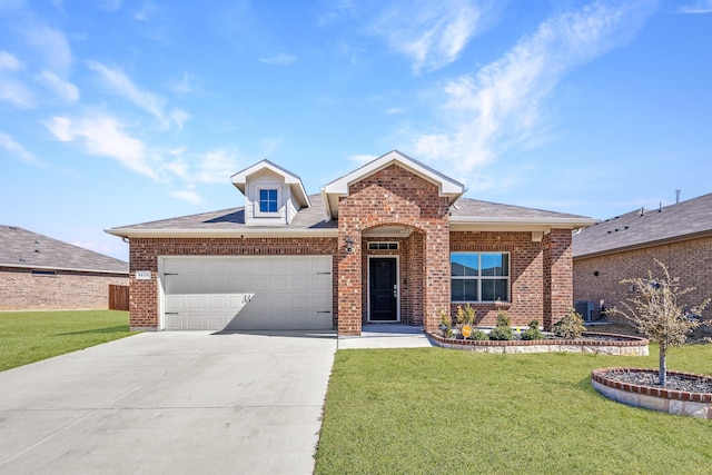 single story home featuring a garage, concrete driveway, brick siding, and a front lawn