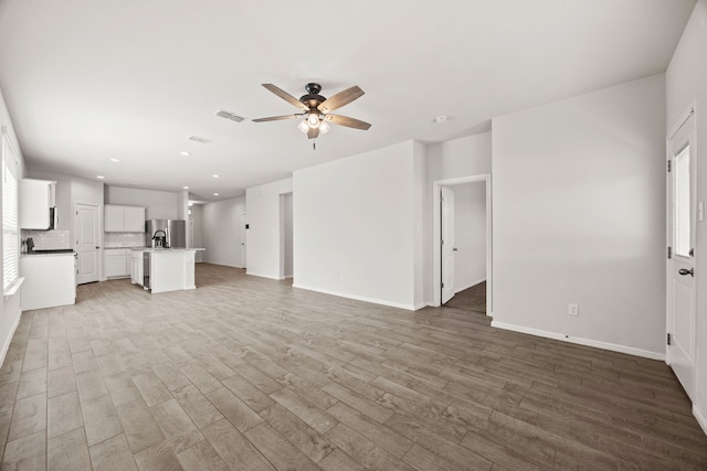 unfurnished living room featuring recessed lighting, wood finished floors, visible vents, and a ceiling fan