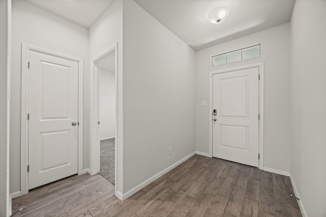 entrance foyer featuring baseboards and wood finished floors