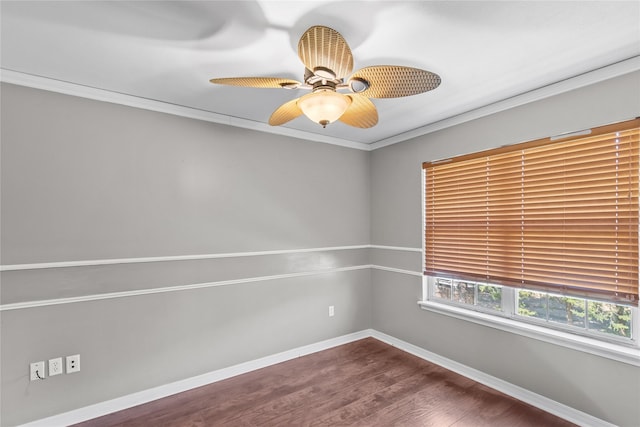 unfurnished room with a ceiling fan, crown molding, baseboards, and wood finished floors