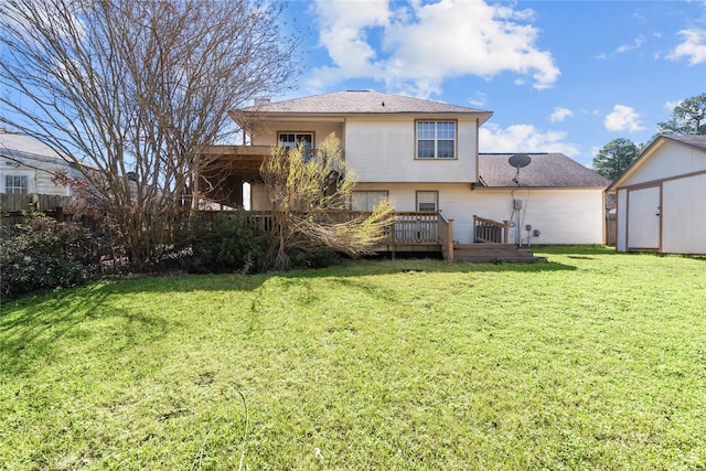 rear view of property featuring a chimney, a yard, a deck, an outdoor structure, and a shed