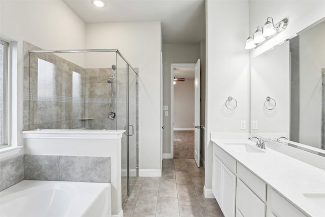 bathroom featuring a garden tub, double vanity, a stall shower, a sink, and tile patterned floors