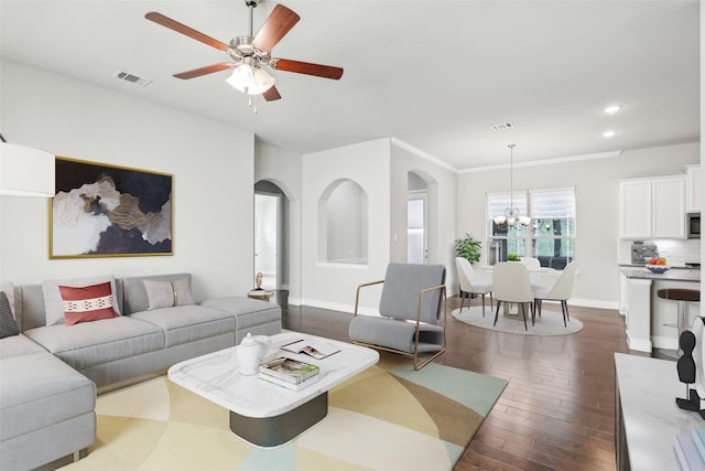 living area featuring baseboards, visible vents, arched walkways, dark wood-style flooring, and recessed lighting