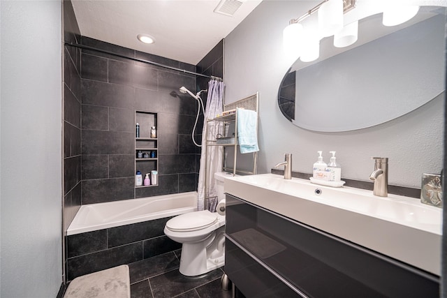 full bath with toilet, tiled shower / bath combo, vanity, visible vents, and tile patterned floors