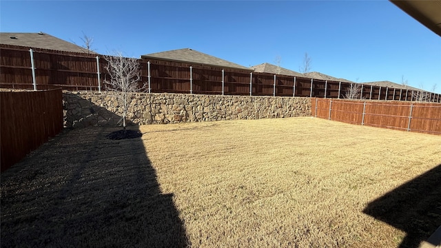 view of yard with a fenced backyard