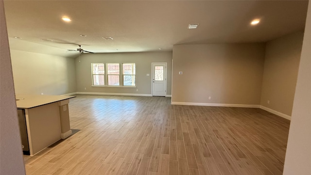 unfurnished living room with visible vents, baseboards, ceiling fan, light wood-style floors, and recessed lighting