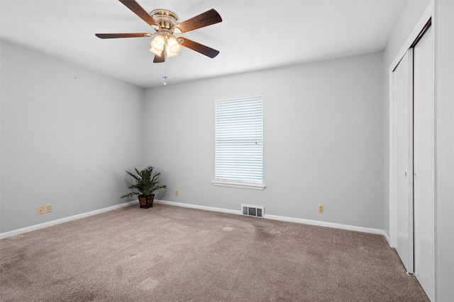 unfurnished bedroom with carpet floors, a closet, visible vents, and baseboards