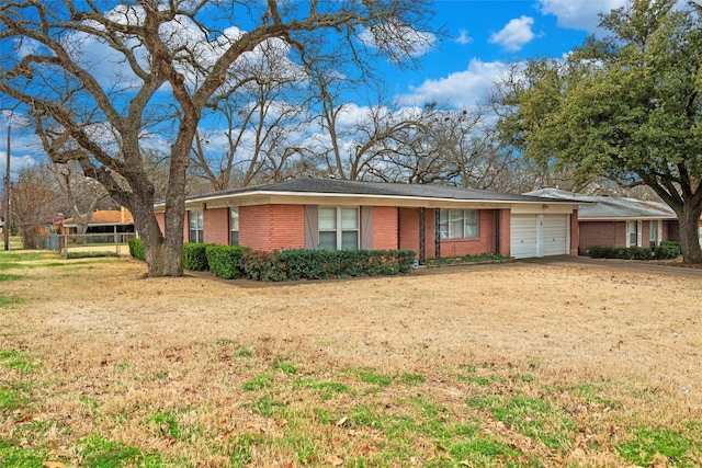 single story home featuring a garage, brick siding, fence, driveway, and a front lawn