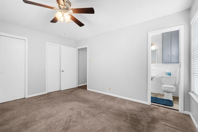 unfurnished bedroom featuring baseboards, a ceiling fan, connected bathroom, carpet flooring, and multiple closets