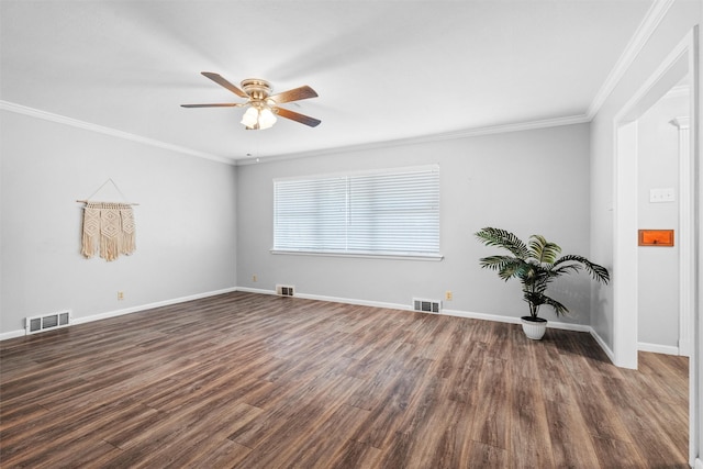 empty room with dark wood-type flooring, visible vents, and crown molding