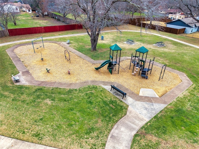 community jungle gym featuring a yard and fence