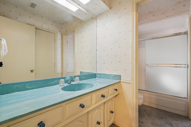 bathroom featuring toilet, wallpapered walls, visible vents, and vanity