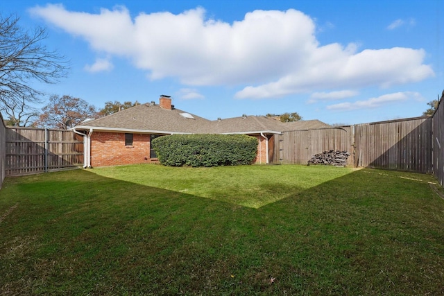 view of yard with a fenced backyard