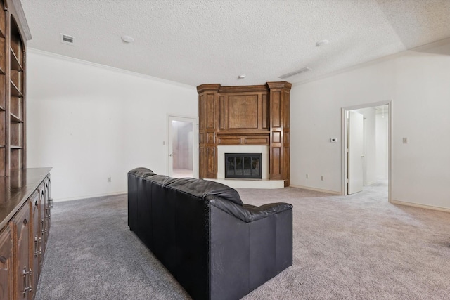 living area with a large fireplace, carpet, visible vents, and baseboards