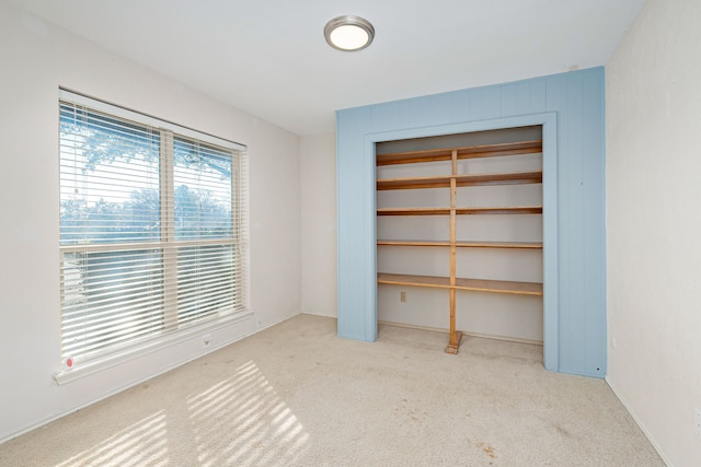 unfurnished bedroom featuring a closet and carpet flooring