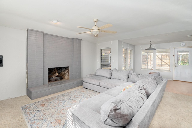 living room featuring a ceiling fan and a fireplace