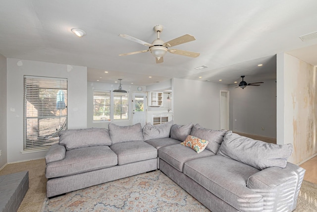 living room featuring baseboards, visible vents, light colored carpet, and recessed lighting