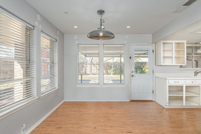 unfurnished dining area featuring light wood-type flooring, baseboards, visible vents, and recessed lighting