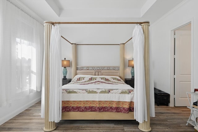 bedroom featuring baseboards and wood finished floors