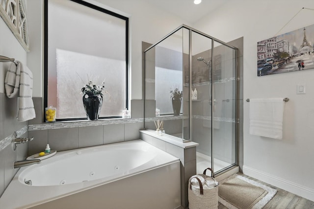 full bath with baseboards, a shower stall, and a whirlpool tub