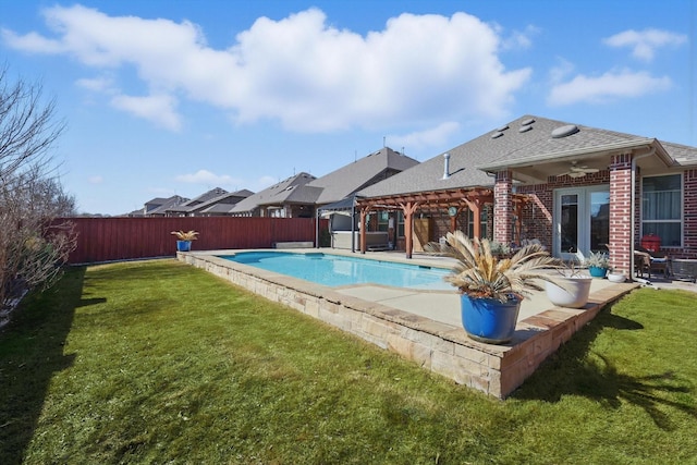 view of pool with a fenced backyard, ceiling fan, a yard, a patio area, and a pergola