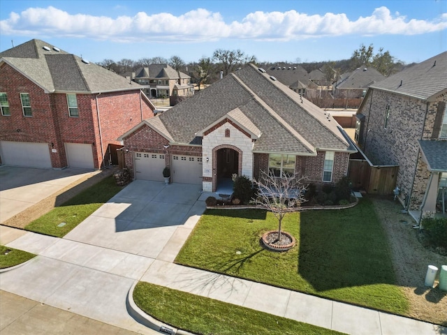 view of front of house featuring concrete driveway, stone siding, roof with shingles, a front lawn, and brick siding