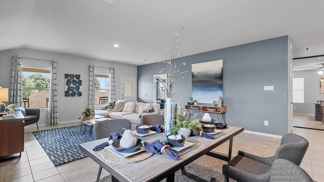 living area featuring ceiling fan, light tile patterned flooring, and baseboards