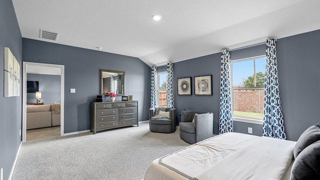 carpeted bedroom featuring baseboards, multiple windows, visible vents, and vaulted ceiling