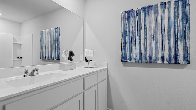 full bathroom with double vanity and a sink