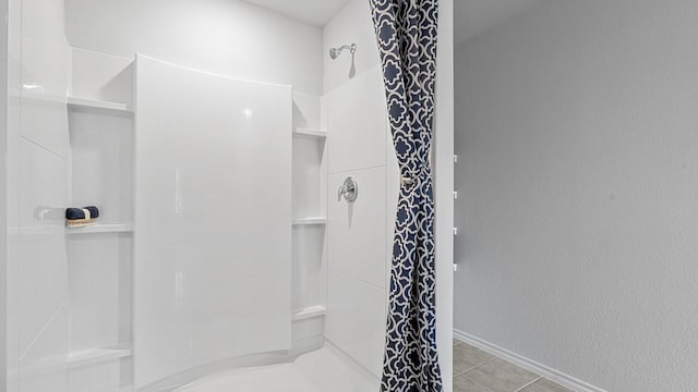 full bath featuring a shower and tile patterned floors