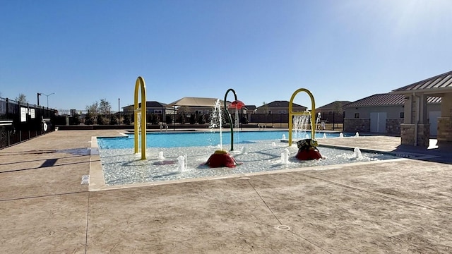 community pool featuring community basketball court and fence