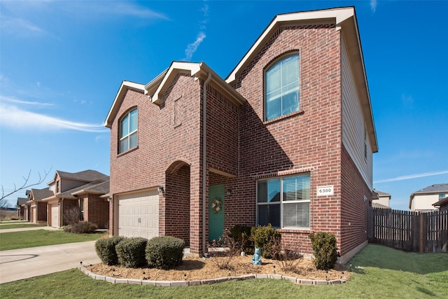 view of front of house with a garage, driveway, fence, a front lawn, and brick siding