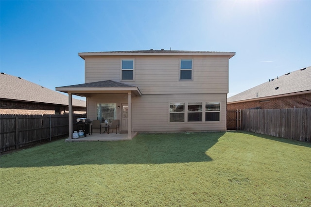 back of property featuring a patio area, a fenced backyard, and a yard