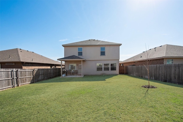 back of property with a yard, a patio, and a fenced backyard