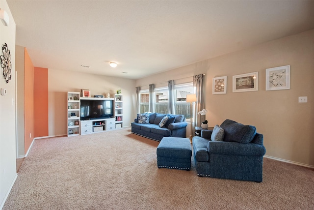 living area featuring carpet floors and baseboards