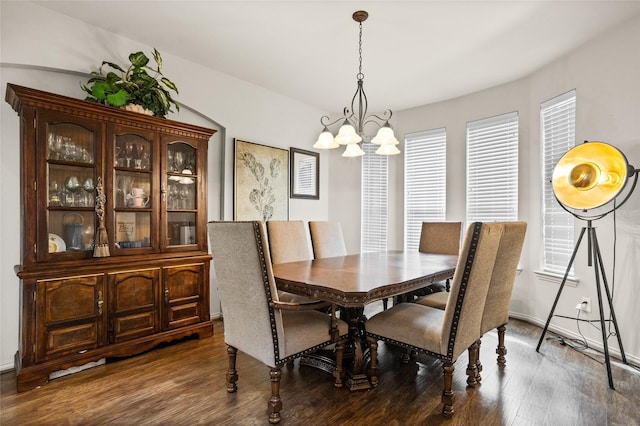 dining area featuring a notable chandelier and wood finished floors