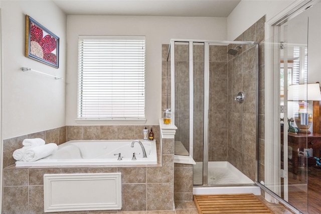 full bathroom with a stall shower and a garden tub