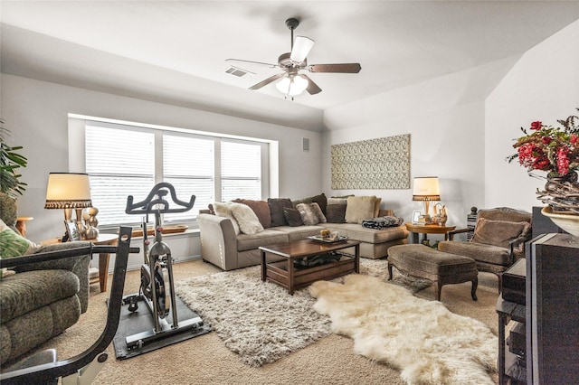 living room with a ceiling fan, lofted ceiling, visible vents, and carpet flooring