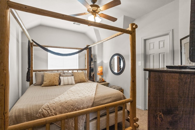 bedroom with ceiling fan, visible vents, vaulted ceiling, and carpet flooring