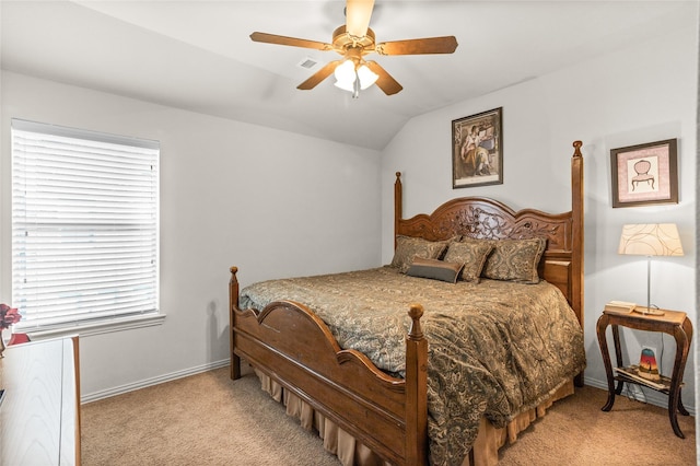 bedroom with carpet flooring, visible vents, a ceiling fan, vaulted ceiling, and baseboards