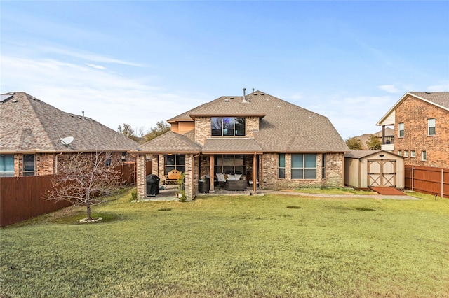 rear view of property featuring an outbuilding, a fenced backyard, roof with shingles, a shed, and a patio area