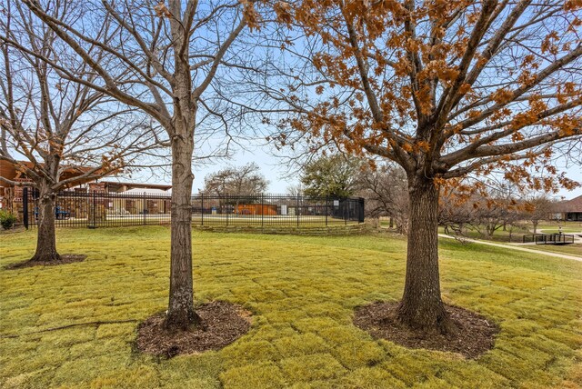 view of front of property featuring a front yard, a standing seam roof, metal roof, fence, and driveway