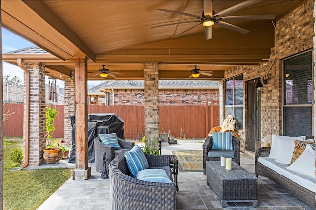 view of patio with a ceiling fan, a grill, outdoor lounge area, and fence