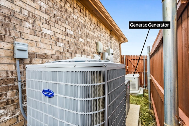 exterior details with central AC, fence, and brick siding